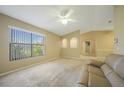 Bright living room with large window and view to kitchen at 4415 Mundella Cir, Port Charlotte, FL 33948