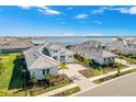 Aerial view of waterfront homes with a community lake at 500 Blue Shell Loop, Sarasota, FL 34240