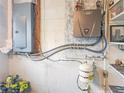 Interior view of the home's mechanical room, showing the water heater and electrical panel at 625 Pompano Ter, Punta Gorda, FL 33950