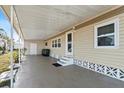 Covered carport and exterior of home with white trim and neutral siding at 6835 Anapa Ct, North Port, FL 34287