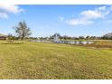 Expansive backyard view of pond with fountain feature, great for outdoor enjoyment at 7325 Mikasa Dr, Punta Gorda, FL 33950