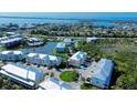 Aerial shot of the community showcasing its end-unit condo, waterfront setting, and beautifully landscaped grounds at 10311 Lands End Cir # 16, Placida, FL 33946