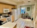 Efficient kitchen with stainless steel appliances and access to the staircase at 1186 Rio De Janeiro Ave # 106, Punta Gorda, FL 33983