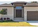 Inviting front entrance with double doors, neutral colors and manicured lawn at 13356 Rayburn Ln, Port Charlotte, FL 33981