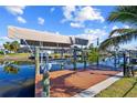 Wooden dock with covered boat lift on a calm canal waterway at 18326 Burkholder Cir, Port Charlotte, FL 33948