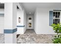 Front entry with paver walkway and blue accents at 1890 Sunset Preserve Way, Port Charlotte, FL 33953