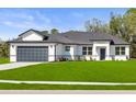 Charming single-story home with a well-maintained lawn and classic white exterior, offering a welcoming curb appeal at 2143 S Haberland Blvd, North Port, FL 34288