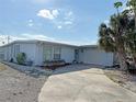 Charming single Gathering home with well-maintained lawn, mature palm trees, and a paved driveway at 21535 Edgewater Dr, Port Charlotte, FL 33952
