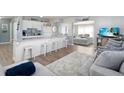 Bright living space with a view of the updated kitchen and a comfortable seating area at 21923 Cellini Ave, Port Charlotte, FL 33952