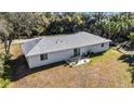 Rear view of home highlighting backyard with patio, table, chairs, and barbecue grill at 2325 Hanford Ln, North Port, FL 34288