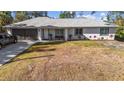 Charming single-story home with a two-car garage, a well-kept lawn, and cozy front porch at 2325 Hanford Ln, North Port, FL 34288