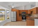 Modern kitchen with stainless steel appliances, ample cabinet space, and a large window overlooking the yard at 2443 Lake View Blvd, Port Charlotte, FL 33948