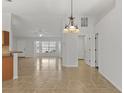 Spacious, open-concept living area with tile flooring, a chandelier, and high ceilings for a grand feel at 2443 Lake View Blvd, Port Charlotte, FL 33948