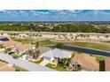 Overhead view of a home next to a golf course and highway, with palm trees for privacy at 24576 Buckingham Way, Punta Gorda, FL 33980