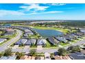 Expansive community aerial view showcasing mature landscaping, golf course and lake at 25186 Keygrass Ct, Punta Gorda, FL 33955