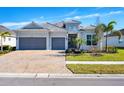 Beautiful two-car garage home featuring an inviting entrance and manicured landscaping at 25186 Keygrass Ct, Punta Gorda, FL 33955