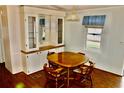 Cozy dining area with built-in cabinet, classic wood table, and hardwood floors at 258 Palm Harbor Dr, North Port, FL 34287