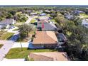 Aerial view of a single-story home featuring a screened-in patio and well-maintained landscaping at 27199 Punta Cabello Ct, Punta Gorda, FL 33983