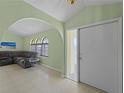 Living room with a sectional sofa, tiled floors, and large windows at 3370 Dover Dr, Punta Gorda, FL 33983