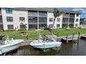 Beautiful waterfront with lush landscaping and two boats docked in the serene waters at 367 Coldeway Dr # H10, Punta Gorda, FL 33950
