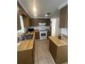 Functional kitchen with ample cabinet space and tile flooring at 432 Olivia Rd, Venice, FL 34293