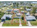 Aerial view showcasing the property's boundaries, pool, outbuilding, and its location within the neighborhood at 530 Lakemont Nw Ave, Port Charlotte, FL 33952