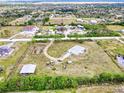 Expansive aerial view of the property showcasing the home, surrounding land, and outbuildings at 6171 Swiss Blvd, Punta Gorda, FL 33982
