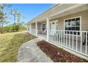 Inviting front porch with seating, white railings, and a landscaped walkway leading to the entrance at 6171 Swiss Blvd, Punta Gorda, FL 33982