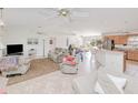 Bright living room featuring tile floors, neutral tones, ceiling fans and an open layout at 6171 Swiss Blvd, Punta Gorda, FL 33982