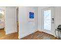 Bright hallway featuring wood-look tile and a decorative front door at 6251 Cassia St, Bradenton, FL 34203