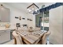 Dining area with sliding door access, decorative chandelier and a table with seating for four at 11637 Woodleaf Dr # 11637, Bradenton, FL 34211