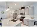 Modern kitchen featuring stainless steel appliances, gray cabinets and a center island with a sink at 11637 Woodleaf Dr # 11637, Bradenton, FL 34211