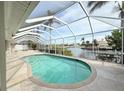 Screened-in pool overlooking the canal, providing a private and relaxing outdoor living space at 1259 Royal Tern Dr, Punta Gorda, FL 33950