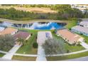 An aerial view of the home and community showcasing the homes' solar panels and nearby pond at 1578 Scarlett Ave, North Port, FL 34289