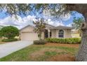 Charming single Gathering home featuring a manicured front yard and an attached two-car garage at 1578 Scarlett Ave, North Port, FL 34289