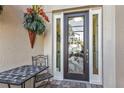 Elegant front door with decorative glass and a cozy outdoor seating area at 1620 Lancashire Dr, Venice, FL 34293