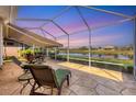 Relaxing screened patio overlooking a tranquil pond, perfect for outdoor living at 1771 Scarlett Ave, North Port, FL 34289