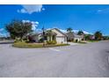 A cozy home with a two-car garage, green lawn, and mature trees located on a corner lot in the neighborhood at 1800 Birmingham Blvd, Punta Gorda, FL 33980