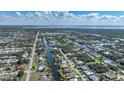 Stunning aerial view of a waterfront neighborhood, with a home circled on a canal, near a bay and a preserved wetland at 18702 Van Nuys Cir, Port Charlotte, FL 33948