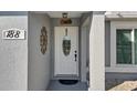 Close-up of the front door with decorative accents and the house number displayed above it at 188 Cypress Nw Ave, Port Charlotte, FL 33952