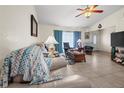 Bright living room featuring tile floors, comfortable seating, and a view of the front entry at 188 Cypress Nw Ave, Port Charlotte, FL 33952