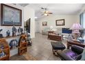 Spacious living room with tile flooring, ceiling fan, and cozy furniture arrangement at 188 Cypress Nw Ave, Port Charlotte, FL 33952