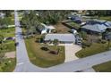 Aerial view of the property showing a well-maintained home with a large yard and surrounding neighborhood at 21192 Knollwood Ave, Port Charlotte, FL 33952