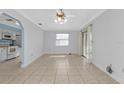 Bright living room featuring tile floors, modern ceiling fan, and sliding glass doors to the outside at 25068 Harborview Rd # 3B, Punta Gorda, FL 33980