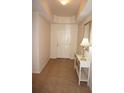 Inviting hallway with tile flooring and a console table, illuminated by a ceiling light and a table lamp at 255 West End Dr # 1302, Punta Gorda, FL 33950