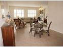 Cozy living room featuring neutral tones, tile flooring, shuttered windows, and comfortable seating at 255 West End Dr # 1302, Punta Gorda, FL 33950