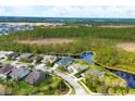 Aerial view of a residential neighborhood showcasing the community's serene setting by a nature preserve at 2639 Hobblebrush Dr, North Port, FL 34289