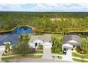 Scenic aerial view of a home with a serene pond in the backyard and lush greenery surrounding the property at 2639 Hobblebrush Dr, North Port, FL 34289