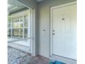 Close up of a welcoming front door with stone accents, a peep hole, and modern hardware at 27385 Neaptide Dr, Punta Gorda, FL 33983