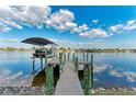 Beautiful private wooden dock with covered boat lift on tranquil water at 349 Springview Nw Cir, Port Charlotte, FL 33948